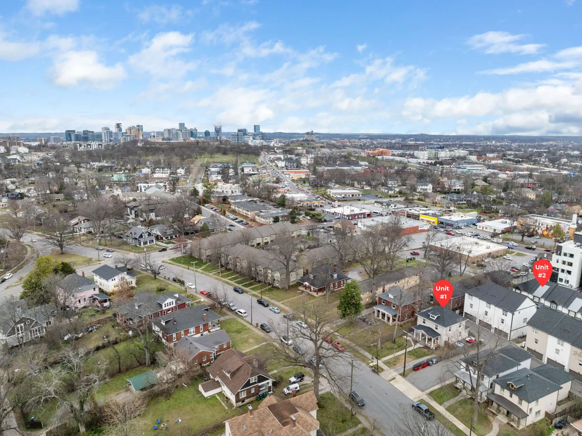 A panoramic city view showing the Nashville downtown skyline, residential neighborhoods, and specific units marked. The bustling city environment invites exploration and showcases how close the property is to entertainment, dining, and event opportunities.