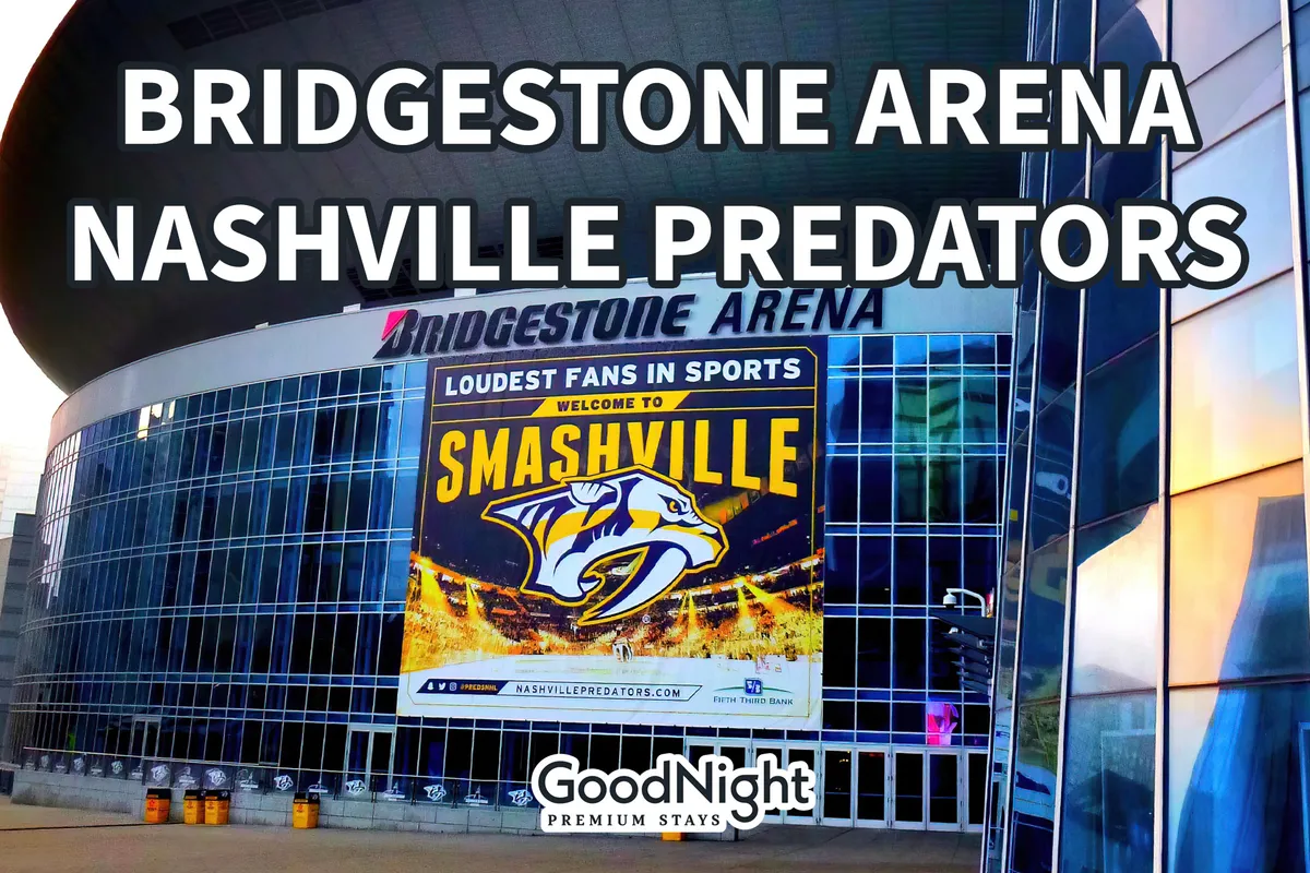 The exterior of Bridgestone Arena, featuring prominent signage, the Nashville Predators logo, and a large 'Welcome to Smashville' banner. The energy of the entertainment district can be felt through the bustling surroundings and vibrant banners.